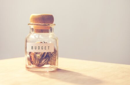 Small jar of coins labelled 'Budget'