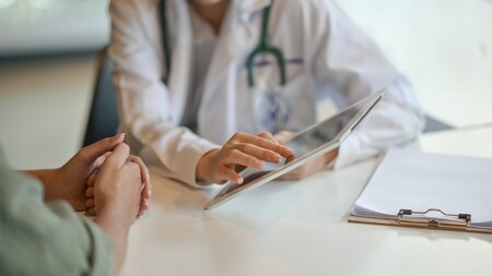 doctors hands consulting patient sitting down
